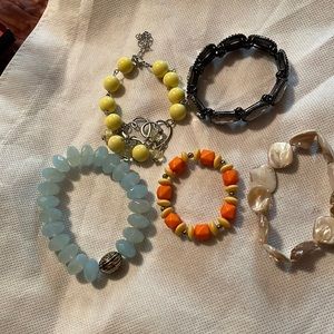Assorted stretch bracelets. Yellow one has clasp